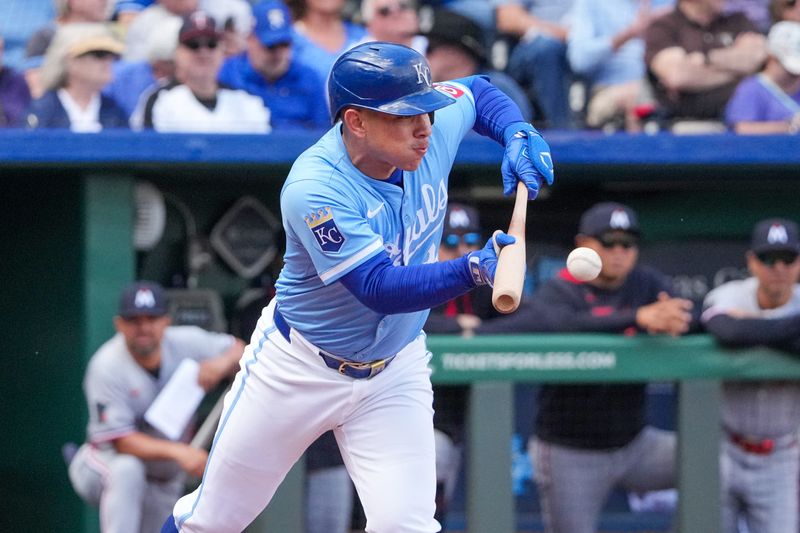 Apr 10, 2025; Kansas City, Missouri, USA; Kansas City Royals catcher Freddy Fermin (34) bunts for a single against the Minnesota Twins in the fifth inning at Kauffman Stadium. Mandatory Credit: Denny Medley-Imagn Images
