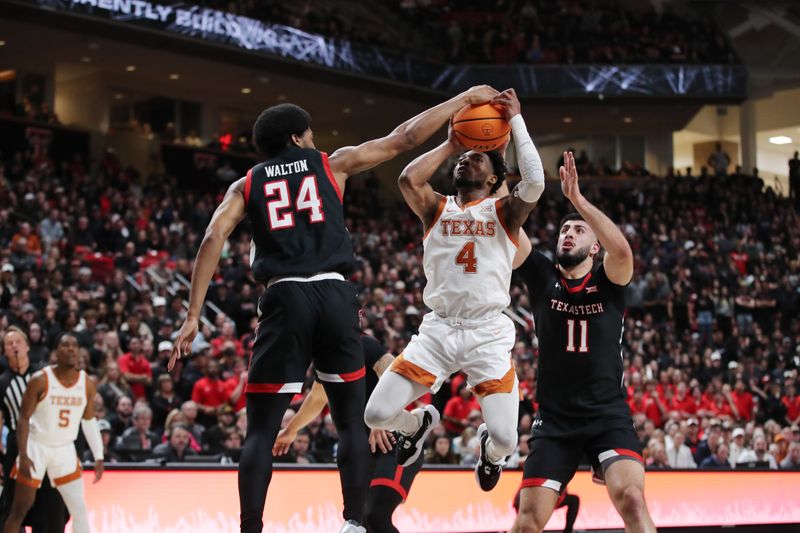 Feb 13, 2023; Lubbock, Texas, USA;  Texas Tech Red Raiders guard Kerwin Walton (24) blocks a shot by Texas Longhorns guard Tyrse Hunter (4) in the first half at United Supermarkets Arena. Mandatory Credit: Michael C. Johnson-USA TODAY Sports