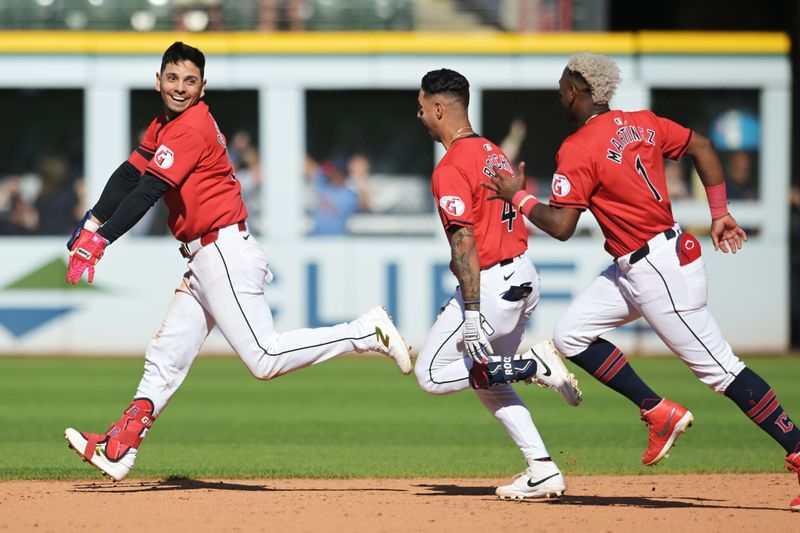 Sep 19, 2024; Cleveland, Ohio, USA; Cleveland Guardians second baseman Andres Gimenez (0) celebrates with shortstop Brayan Rocchio (4) and left fielder Angel Martinez (1) after getting the game-winning hit during the tenth inning against the Minnesota Twins at Progressive Field. With the win the Guardians clinched a playoff berth. Mandatory Credit: Ken Blaze-Imagn Images