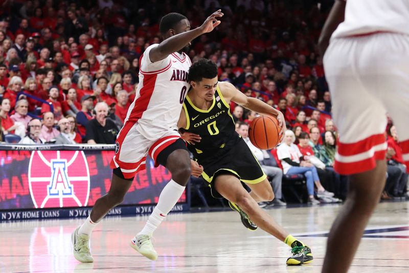 Feb 2, 2023; Tucson, Arizona, USA;Oregon Ducks guard Will Richardson (0) drives to the net against Arizona Wildcats guard Courtney Ramey (0) in the first half at McKale Center. Mandatory Credit: Zachary BonDurant-USA TODAY Sports