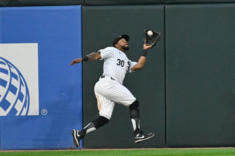 Jul 12, 2024; Chicago, Illinois, USA;  Chicago White Sox outfielder Corey Julks (30) catches a fly ball hit by Pittsburgh Pirates outfielder Michael A. Taylor (18) during the fifth inning  at Guaranteed Rate Field. Mandatory Credit: Matt Marton-USA TODAY Sports