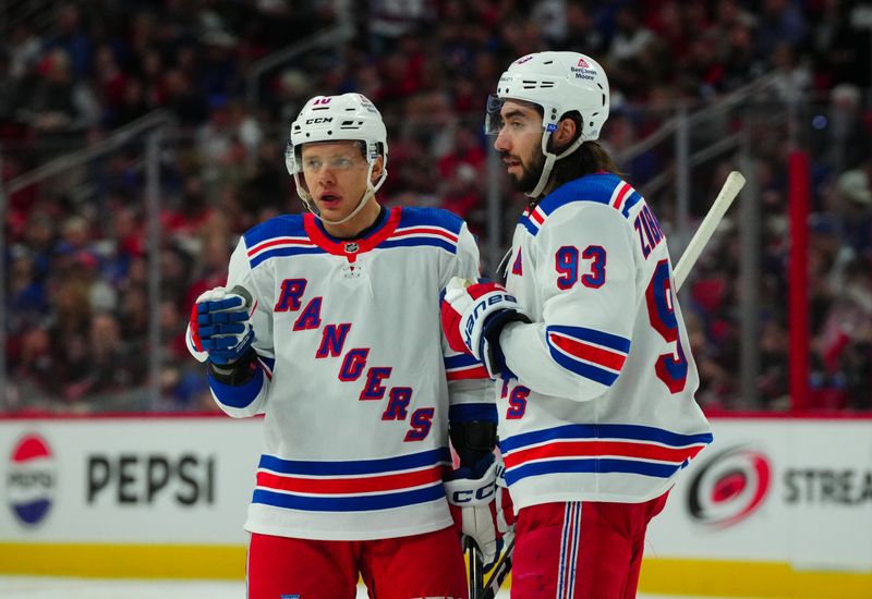 Mar 12, 2024; Raleigh, North Carolina, USA; New York Rangers left wing Artemi Panarin (10) and center Mika Zibanejad (93) talk during the second period against the Carolina Hurricanes at PNC Arena. Mandatory Credit: James Guillory-USA TODAY Sports