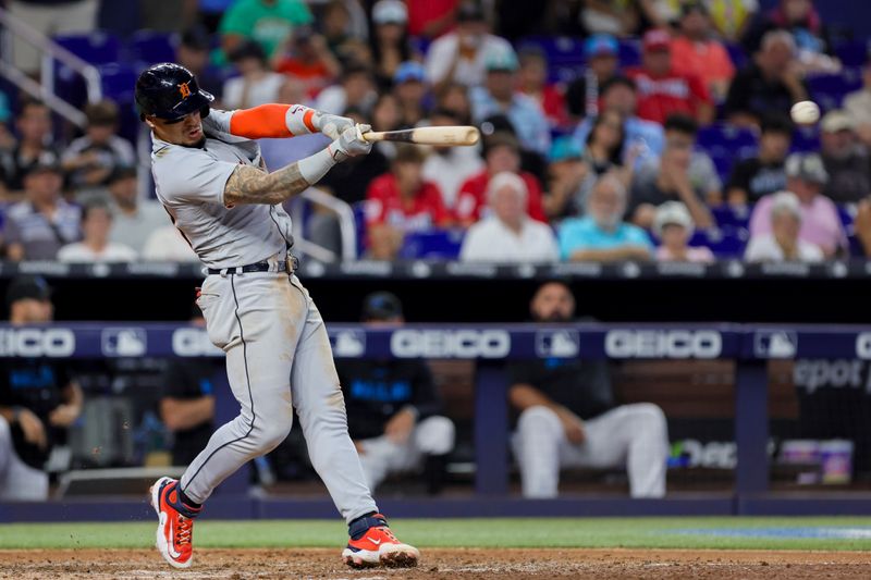 Jul 30, 2023; Miami, Florida, USA; Detroit Tigers shortstop Javier Baez (28) hits a single against the Miami Marlins during the seventh inning at loanDepot Park. Mandatory Credit: Sam Navarro-USA TODAY Sports