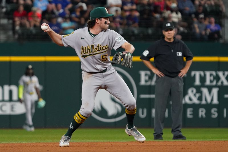 Apr 28, 2025; Arlington, Texas, USA; Athletics shortstop Jacob Wilson (5) throws to first base during the fourth inning  for the put out against the Texas Rangers at Globe Life Field. Mandatory Credit: Raymond Carlin III-Imagn Images