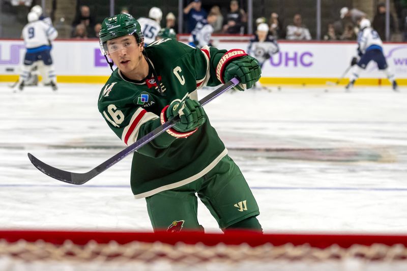 Nov 25, 2024; Saint Paul, Minnesota, USA;  Minnesota Wild defenseman Jared Spurgeon (46) shoots a puck during warm up before a game against the Winnipeg Jets at Xcel Energy Center. Mandatory Credit: Nick Wosika-Imagn Images