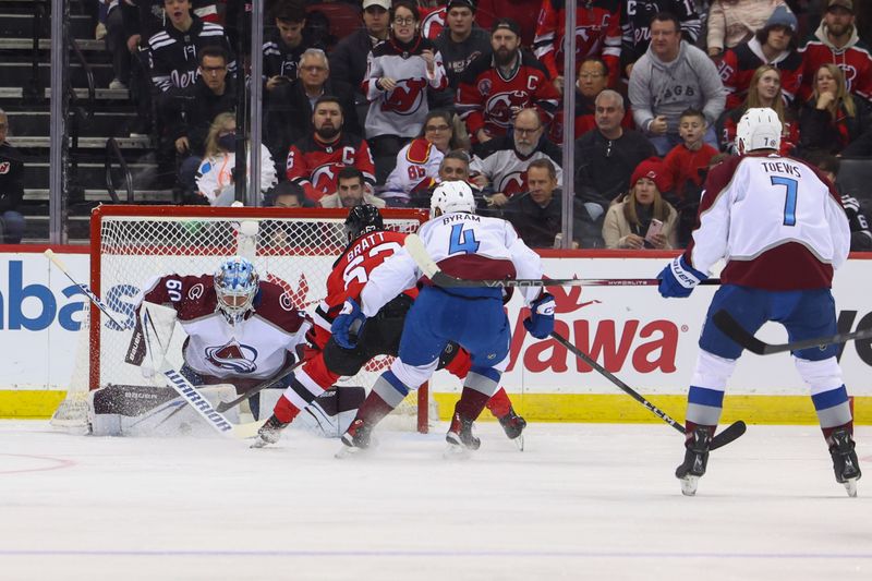 Feb 6, 2024; Newark, New Jersey, USA; Colorado Avalanche goaltender Justus Annunen (60) makes a save on New Jersey Devils left wing Jesper Bratt (63) during the first period at Prudential Center. Mandatory Credit: Ed Mulholland-USA TODAY Sports