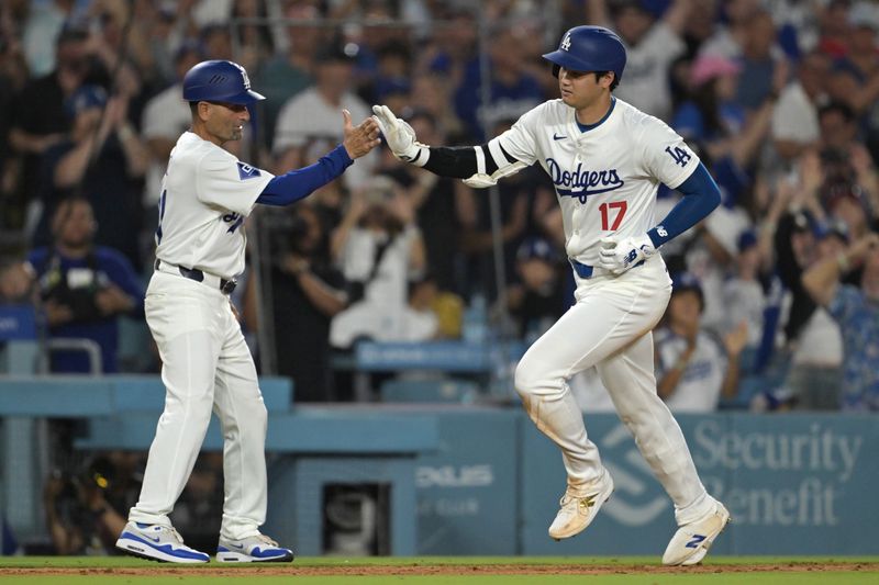 Aug 5, 2024; Los Angeles, California, USA;  Los Angeles Dodgers designated hitter Shohei Ohtani (17) is greeted by third base coach Dino Ebel (91) after hitting a solo home run in the eighth inning against the Philadelphia Phillies at Dodger Stadium. Mandatory Credit: Jayne Kamin-Oncea-USA TODAY Sports