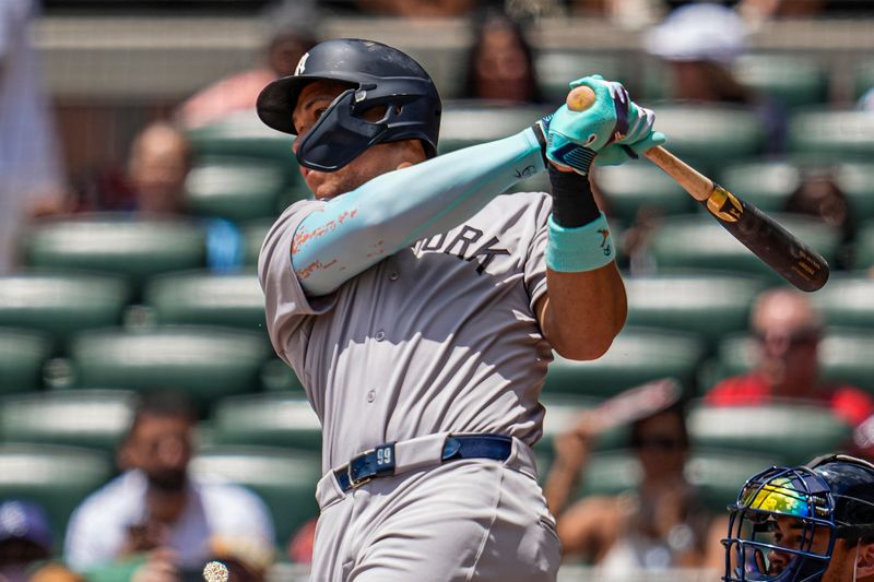 Jul 20, 2025; Cumberland, Georgia, USA; New York Yankees right fielder Aaron Judge (99) hits a home run against the Atlanta Braves during the first inning at Truist Park. Mandatory Credit: Dale Zanine-Imagn Images