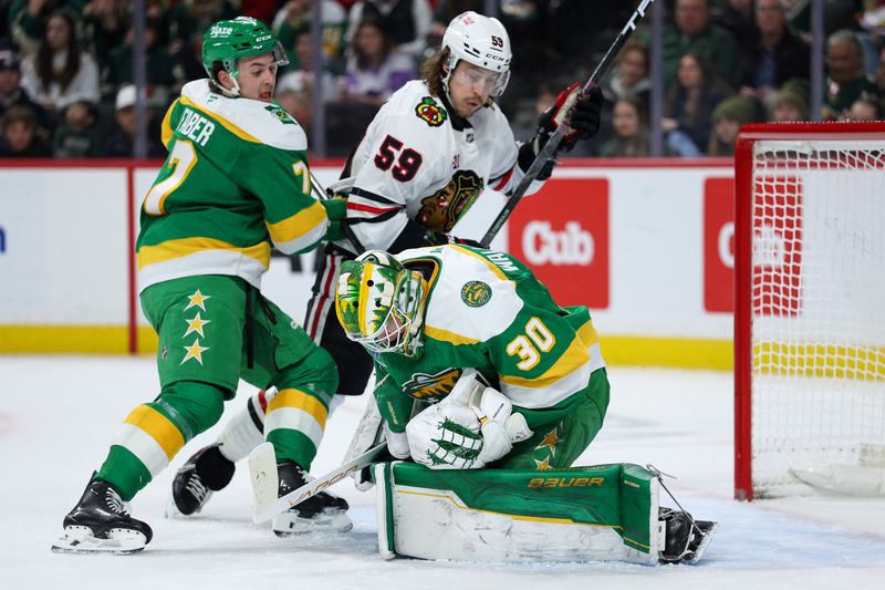 Jan 27, 2026; Saint Paul, Minnesota, USA; Minnesota Wild goaltender Jesper Wallstedt (30) makes a save against the Chicago Blackhawks during the first period at Grand Casino Arena. Mandatory Credit: Matt Krohn-Imagn Images