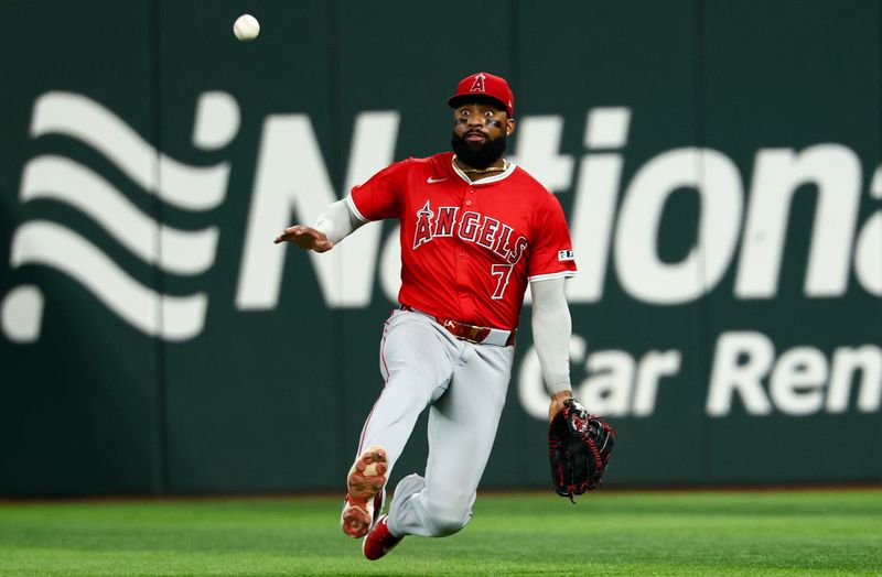Aug 27, 2025; Arlington, Texas, USA;  Los Angeles Angels right fielder Jo Adell (7) dives for but cannot make a catch during the fourth inning against the Texas Rangers at Globe Life Field. Mandatory Credit: Kevin Jairaj-Imagn Images