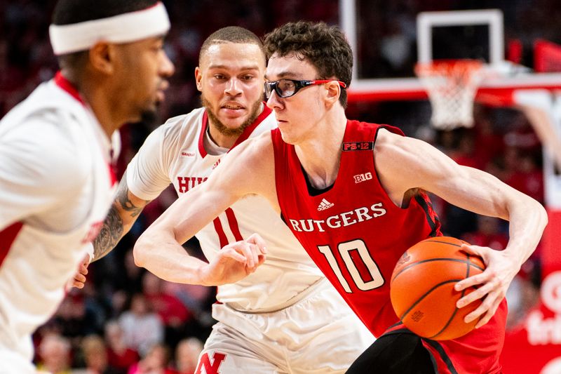 Mar 3, 2024; Lincoln, Nebraska, USA; Rutgers Scarlet Knights guard Gavin Griffiths (10) drives against Nebraska Cornhuskers guard C.J. Wilcher (0) during the second half at Pinnacle Bank Arena. Mandatory Credit: Dylan Widger-USA TODAY Sports