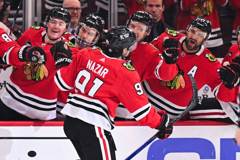 Apr 14, 2024; Chicago, Illinois, USA; Chicago Blackhawks forward Frank Nazar (91) celebrates with the bench after scoring his first NHL goal in his NHL debut in the first period against the Carolina Hurricanes at United Center. Mandatory Credit: Jamie Sabau-USA TODAY Sports