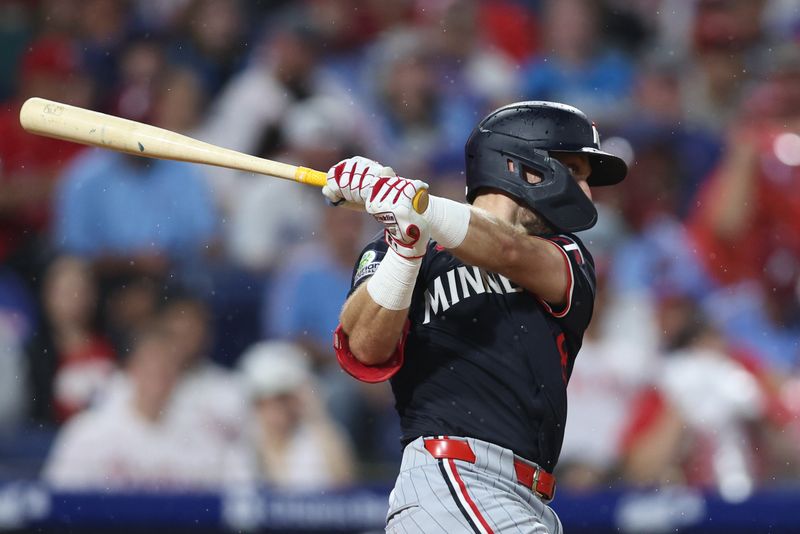 Sep 27, 2025; Philadelphia, Pennsylvania, USA; Minnesota Twins second base Kody Clemens (18) hits a single during the fourth inning against the Philadelphia Phillies at Citizens Bank Park. Mandatory Credit: Bill Streicher-Imagn Images
