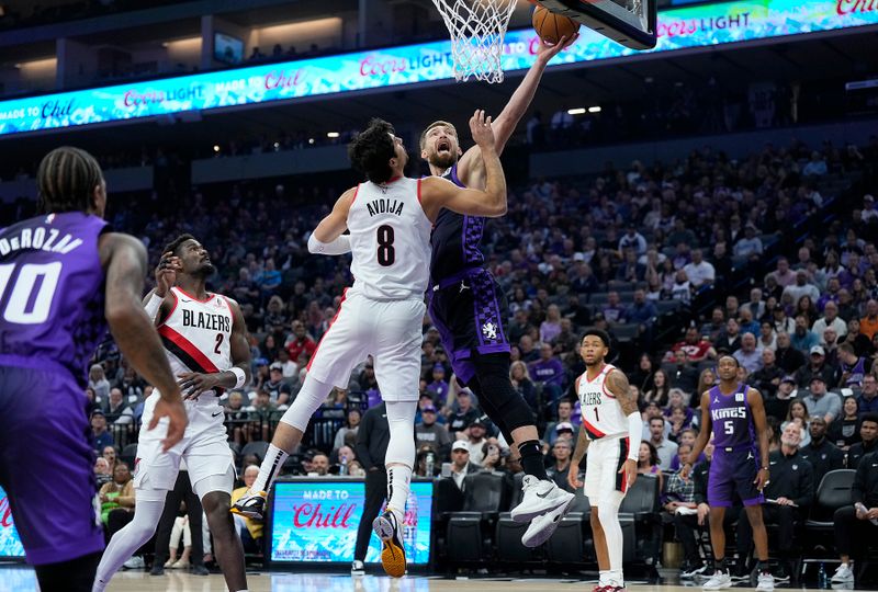 SACRAMENTO, CALIFORNIA - OCTOBER 28: Domantas Sabonis #11 of the Sacramento Kings shoots over Deni Avdija #8 of the Portland Trail Blazers during the first quarter at Golden 1 Center on October 28, 2024 in Sacramento, California. NOTE TO USER: User expressly acknowledges and agrees that, by downloading and or using this photograph, User is consenting to the terms and conditions of the Getty Images License Agreement. (Photo by Thearon W. Henderson/Getty Images)