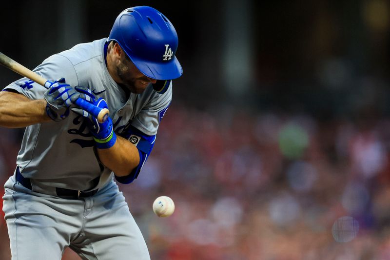 May 24, 2024; Cincinnati, Ohio, USA; Los Angeles Dodgers outfielder Chris Taylor (3) gets hit by a wild pitch in the fifth inning against the Cincinnati Reds at Great American Ball Park. Mandatory Credit: Katie Stratman-USA TODAY Sports