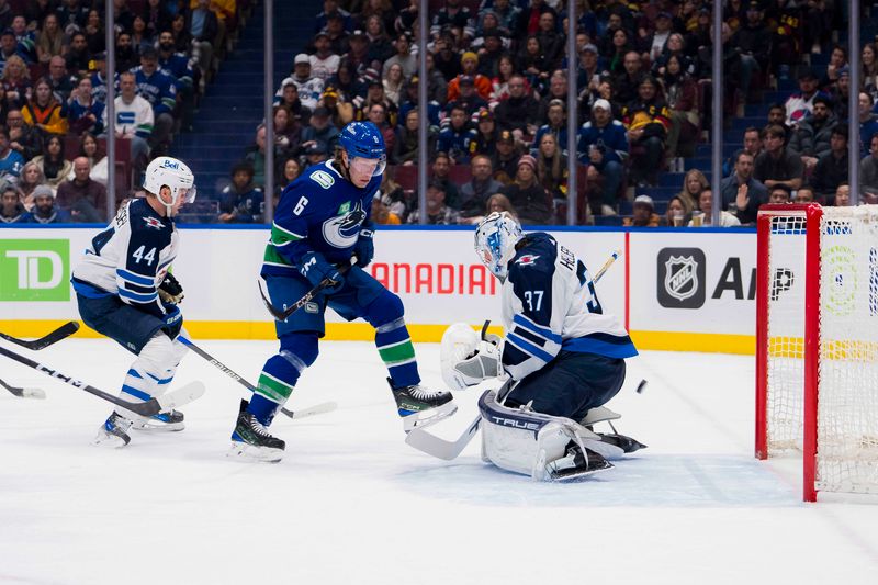 Feb 17, 2024; Vancouver, British Columbia, CAN; Winnipeg Jets defenseman Josh Morrissey (44) and Vancouver Canucks forward Brock Boeser (6) watch the shot from defenseman Tyler Myers (57) beat goalie Connor Hellebuyck (37) in the second period at Rogers Arena. Mandatory Credit: Bob Frid-USA TODAY Sports