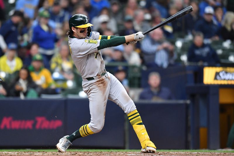 Apr 20, 2025; Milwaukee, Wisconsin, USA; Athletics shortstop Jacob Wilson (5) hits a single during the seventh inning against the Milwaukee Brewers at American Family Field. Mandatory Credit: Patrick Gorski-Imagn Images