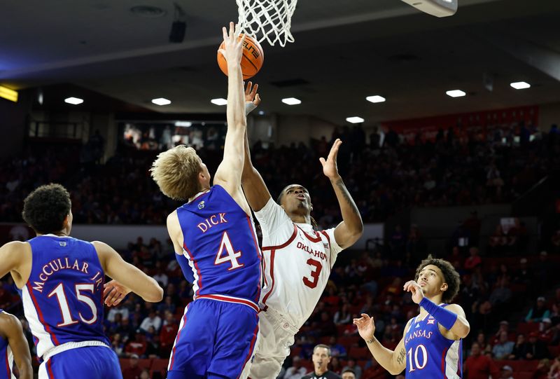 Feb 11, 2023; Norman, Oklahoma, USA; Oklahoma Sooners guard Otega Oweh (3) shoots as Kansas Jayhawks guard Dajuan Harris Jr. (3) defends the basket during the second half at Lloyd Noble Center. Kansas won 78-55. Mandatory Credit: Alonzo Adams-USA TODAY Sports