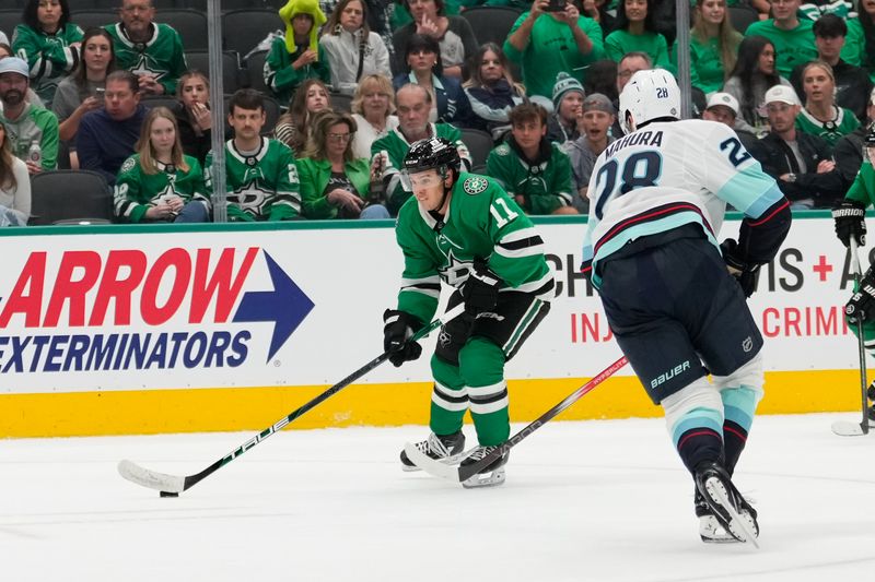 Oct 13, 2024; Dallas, Texas, USA;  Dallas Stars center Logan Stankoven (11) skates with the puck as Seattle Kraken defenseman Joshua Mahura (28) defends during the second period at American Airlines Center. Mandatory Credit: Chris Jones-Imagn Images