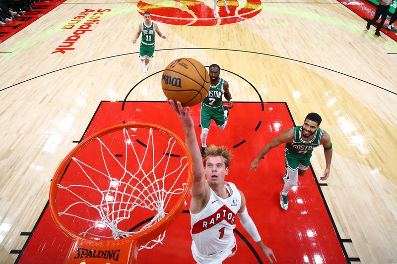 TORONTO, CANADA - OCTOBER 15: Gradey Dick #1 of the Toronto Raptors drives to the basket during the game against the Boston Celtics on October 15, 2024 at the Scotiabank Arena in Toronto, Ontario, Canada.  NOTE TO USER: User expressly acknowledges and agrees that, by downloading and or using this Photograph, user is consenting to the terms and conditions of the Getty Images License Agreement.  Mandatory Copyright Notice: Copyright 2024 NBAE (Photo by Vaughn Ridley/NBAE via Getty Images)