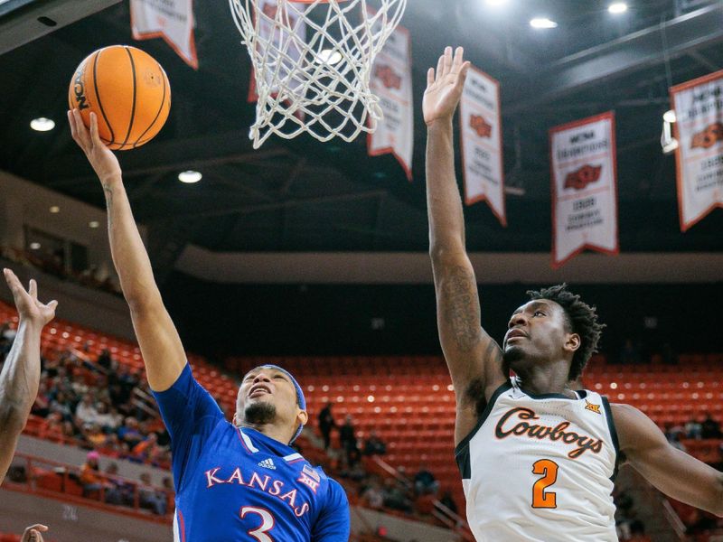 Jan 16, 2024; Stillwater, Oklahoma, USA; Kansas Jayhawks guard Dajuan Harris Jr. (3) puts up a shot in front of Oklahoma State Cowboys forward Eric Dailey Jr. (2) during the second half at Gallagher-Iba Arena. Mandatory Credit: William Purnell-USA TODAY Sports