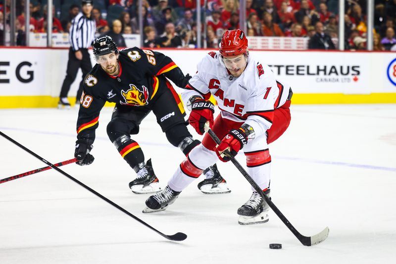 Oct 24, 2024; Calgary, Alberta, CAN; Carolina Hurricanes defenseman Dmitry Orlov (7) controls the puck against the Calgary Flames during the first period at Scotiabank Saddledome. Mandatory Credit: Sergei Belski-Imagn Images