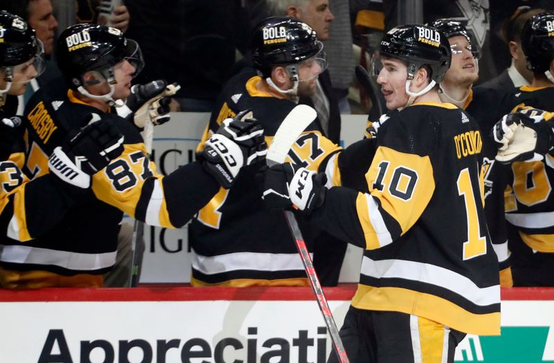 Jan 13, 2023; Pittsburgh, Pennsylvania, USA; Pittsburgh Penguins left wing Drew O'Connor (10) celebrates his goal with the Pens bench against the Winnipeg Jets during the first period at PPG Paints Arena. Mandatory Credit: Charles LeClaire-USA TODAY Sports