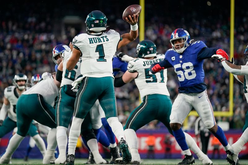 Philadelphia Eagles quarterback Jalen Hurts (1) throws the ball during an NFL football game against the New York Giants, Sunday, Jan. 8, 2024, in East Rutherford, N.J. (AP Photo/Bryan Woolston)