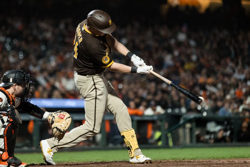 Sep 27, 2023; San Francisco, California, USA; San Diego Padres first baseman Garrett Cooper (24) hits a double against the San Francisco Giants during the ninth inning at Oracle Park. Mandatory Credit: John Hefti-USA TODAY Sports