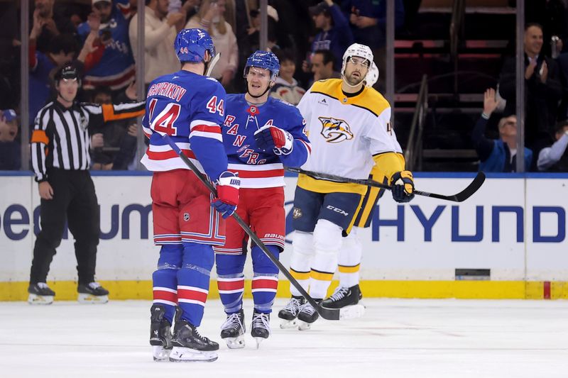 Nov 10, 2025; New York, New York, USA; New York Rangers defenseman Vladislav Gavrikov (44) celebrates his goal against the Nashville Predators with defenseman Adam Fox (23) during the first period at Madison Square Garden. Mandatory Credit: Brad Penner-Imagn Images
