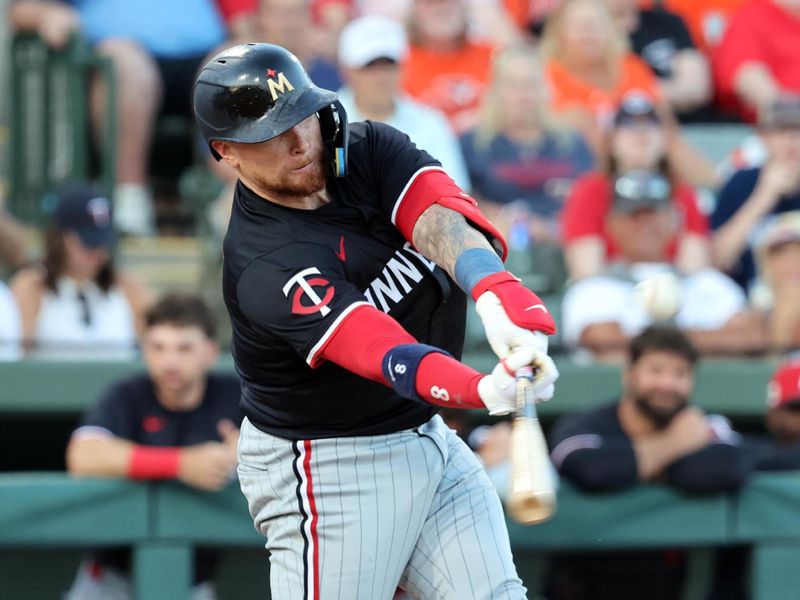 Mar 14, 2025; Sarasota, Florida, USA;  Minnesota Twins catcher Christian Vazquez (8) singles during the fourth inning against the Baltimore Orioles at Ed Smith Stadium. Mandatory Credit: Kim Klement Neitzel-Imagn Images
