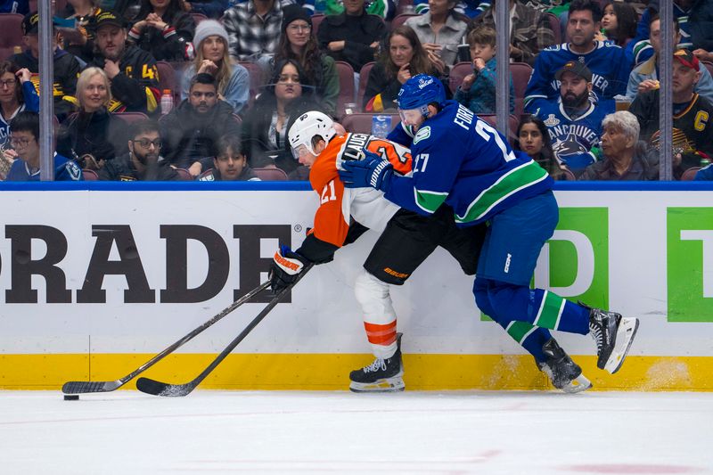 Oct 11, 2024; Vancouver, British Columbia, CAN; Vancouver Canucks defenseman Derek Forbort (27) checks Philadelphia Flyers forward Scott Laughton (21) during the second period at Rogers Arena. Mandatory Credit: Bob Frid-Imagn Images