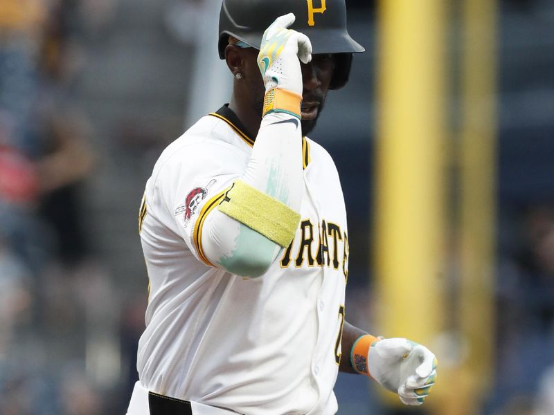 Jul 2, 2024; Pittsburgh, Pennsylvania, USA;  Pittsburgh Pirates designated hitter Andrew McCutchen (22) tips his cap crossing home plate on a solo home run against the St. Louis Cardinals during the fifth inning at PNC Park. Mandatory Credit: Charles LeClaire-USA TODAY Sports