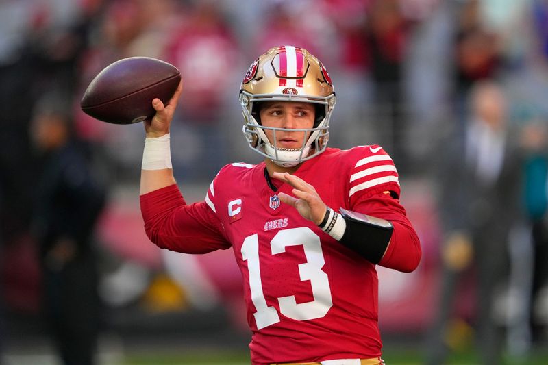 San Francisco 49ers quarterback Brock Purdy (13) warms up before an NFL football game against the Arizona Cardinals Sunday, Dec. 17, 2023, in Glendale, Ariz. (AP Photo/Matt York)