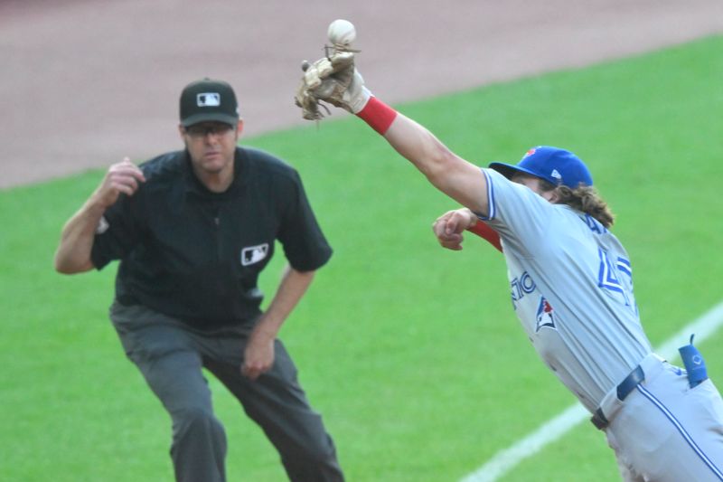 Jun 21, 2024; Cleveland, Ohio, USA; The ball glances off the glove of Toronto Blue Jays third baseman Addison Barger (47) in the second inning against the Cleveland Guardians at Progressive Field. Mandatory Credit: David Richard-USA TODAY Sports