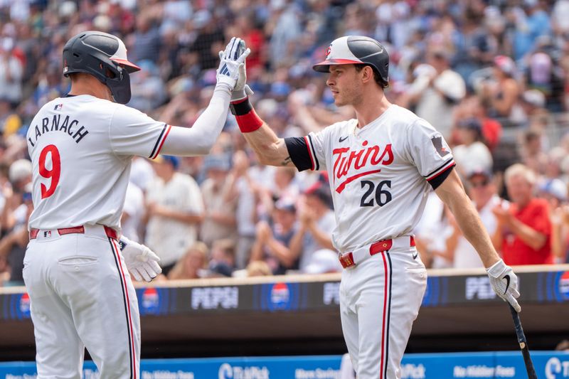 Jul 21, 2024; Minneapolis, Minnesota, USA; Minnesota Twins designated hitter Trevor Larnach (9) is congratulated by Minnesota Twins right field Max Kepler (26) after hitting a two run home run in the fifth inning at Target Field. Mandatory Credit: Matt Blewett-USA TODAY Sports