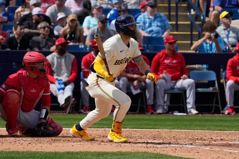 Mar 18, 2024; Phoenix, Arizona, USA; Milwaukee Brewers center fielder Garrett Mitchell (5) hits a single against the Los Angeles Angels in the second inning at American Family Fields of Phoenix. Mandatory Credit: Rick Scuteri-USA TODAY Sports