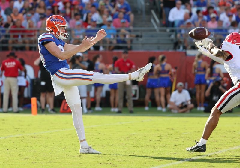 Oct 28, 2023; Jacksonville, Florida, USA; Georgia Bulldogs defensive back Joenel Aguero (8) blocks Florida Gators punter Jeremy Crawshaw (26) punt during the first half at EverBank Stadium. Mandatory Credit: Kim Klement Neitzel-USA TODAY Sports