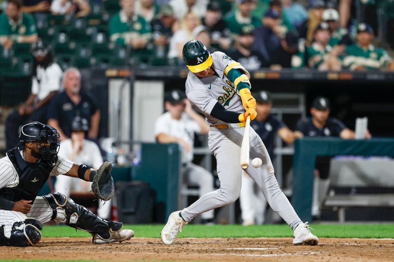 Sep 14, 2024; Chicago, Illinois, USA; Oakland Athletics outfielder Brent Rooker (25) hits a two-run single against the Chicago White Sox during the sixth inning at Guaranteed Rate Field. Mandatory Credit: Kamil Krzaczynski-Imagn Images