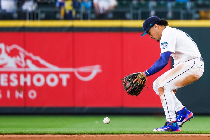 Jun 18, 2023; Seattle, Washington, USA; Seattle Mariners second baseman Kolten Wong (16) attempts to field a ground ball against the Chicago White Sox during the ninth inning at T-Mobile Park. Mandatory Credit: Joe Nicholson-USA TODAY Sports