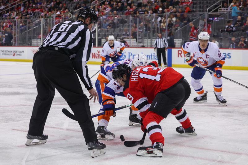 Oct 25, 2024; Newark, New Jersey, USA; New Jersey Devils center Nico Hischier (13) and New York Islanders center Jean-Gabriel Pageau (44) face off during the first period at Prudential Center. Mandatory Credit: Ed Mulholland-Imagn Images