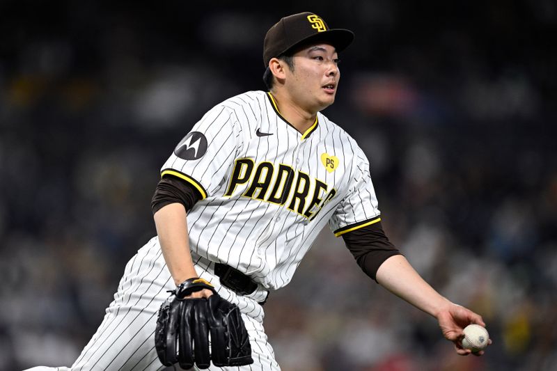 Apr 30, 2024; San Diego, California, USA; San Diego Padres relief pitcher Yuki Matsui (1) tosses the ball to first base during the eighth inning against the Cincinnati Reds at Petco Park. Mandatory Credit: Orlando Ramirez-USA TODAY Sports