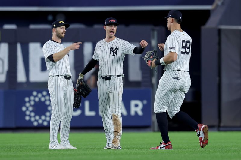 Sep 11, 2025; Bronx, New York, USA; New York Yankees left fielder Austin Slater (29) and center fielder Cody Bellinger (35) and right fielder Aaron Judge (99) celebrate after defeating the Detroit Tigers at Yankee Stadium. Mandatory Credit: Brad Penner-Imagn Images