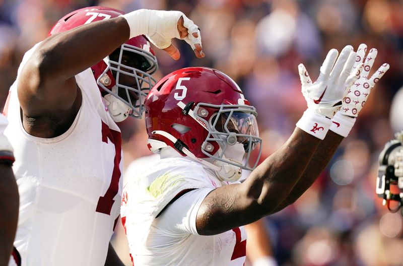 Nov 25, 2023; Auburn, Alabama, USA; Alabama Crimson Tide running back Roydell Williams (5) celebrates his touchdown with teammates against the Auburn Tigers during the first quarter at Jordan-Hare Stadium. Mandatory Credit: John David Mercer-USA TODAY Sports