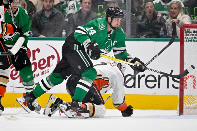 Jan 25, 2024; Dallas, Texas, USA; Dallas Stars left wing Jamie Benn (14) is called for a cross check on Anaheim Ducks defenseman Radko Gudas (7) during the third period at the American Airlines Center. Mandatory Credit: Jerome Miron-USA TODAY Sports