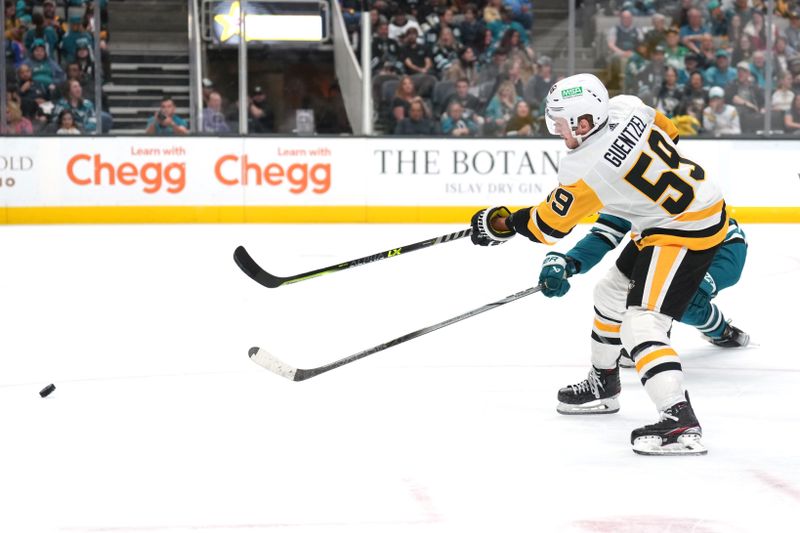 Nov 4, 2023; San Jose, California, USA; Pittsburgh Penguins left wing Jake Guentzel (59) shoots against the San Jose Sharks during the third period at SAP Center at San Jose. Mandatory Credit: Darren Yamashita-USA TODAY Sports