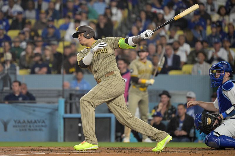 Sep 26, 2024; Los Angeles, California, USA;  San Diego Padres third baseman Manny Machado (13) singles in the fourth inning against the Los Angeles Dodgers at Dodger Stadium. Mandatory Credit: Jayne Kamin-Oncea-Imagn Images