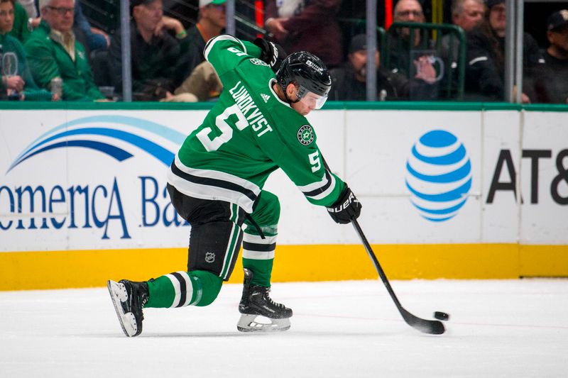 Oct 26, 2023; Dallas, Texas, USA; Dallas Stars defenseman Nils Lundkvist (5) shoots the puck in the Toronto Maple Leafs zone during the third period at the American Airlines Center. Mandatory Credit: Jerome Miron-USA TODAY Sports