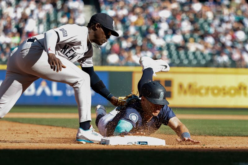 Sep 19, 2024; Seattle, Washington, USA; New York Yankees third baseman Jazz Chisholm Jr. (13) tags out Seattle Mariners second baseman Dylan Moore (25)  during the eighth inning at T-Mobile Park. Mandatory Credit: Joe Nicholson-Imagn Images