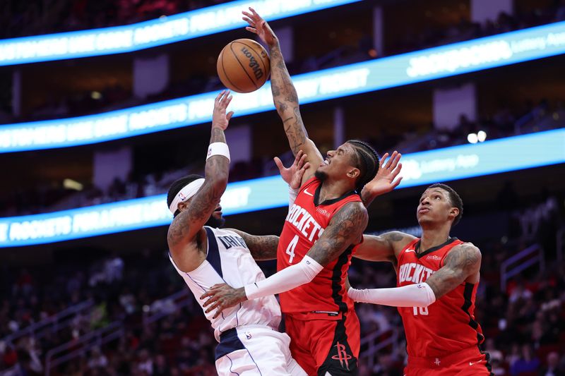 HOUSTON, TEXAS - JANUARY 01: Jalen Green #4 of the Houston Rockets blocks a shot from Jaden Hardy #1 of the Dallas Mavericks during the first half at Toyota Center on January 01, 2025 in Houston, Texas. NOTE TO USER: User expressly acknowledges and agrees that, by downloading and or using this photograph, User is consenting to the terms and conditions of the Getty Images License Agreement. (Photo by Alex Slitz/Getty Images)